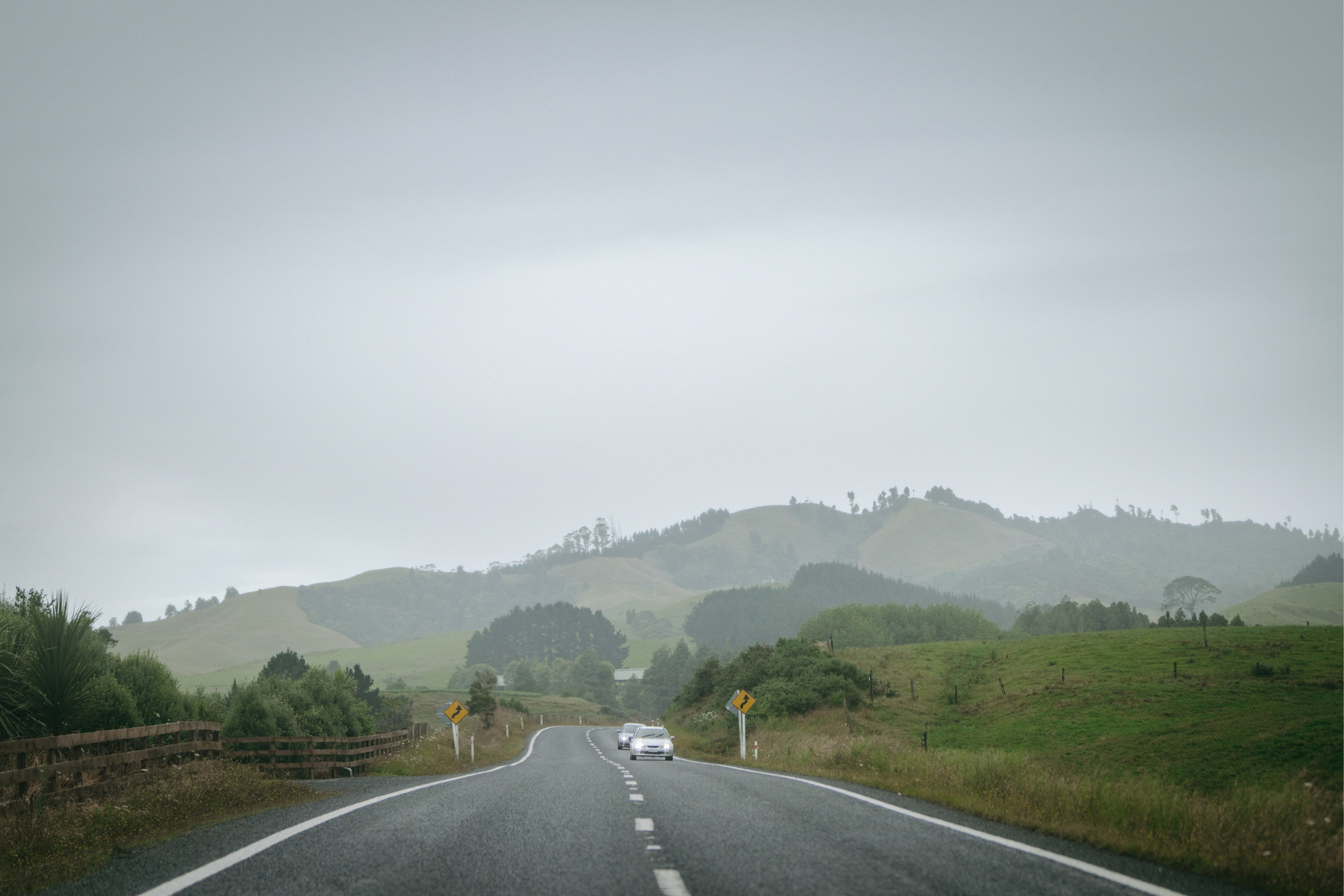 Car driving a road in New Zealand after being bought in another city