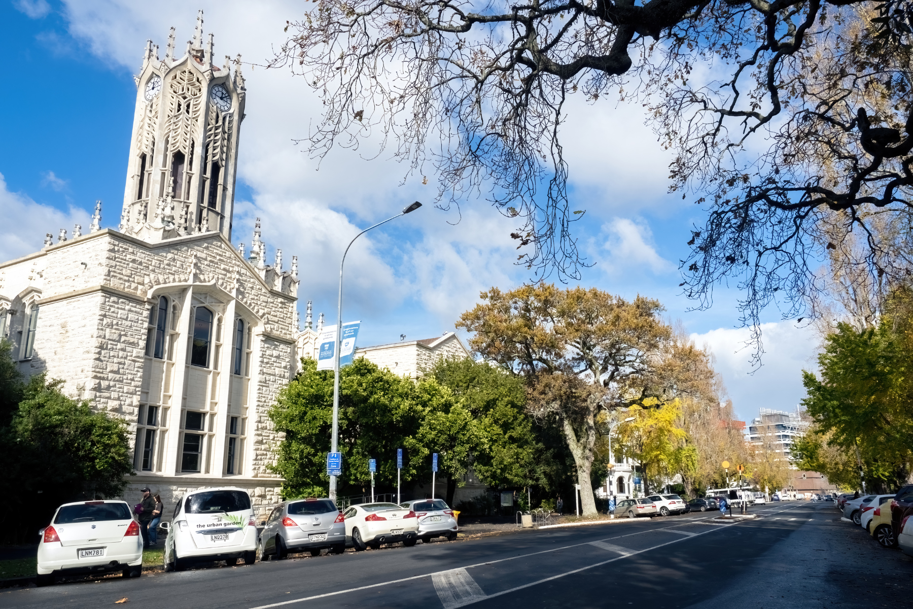 View of cars parked in front of Auckland University Clock Tower Old Arts building