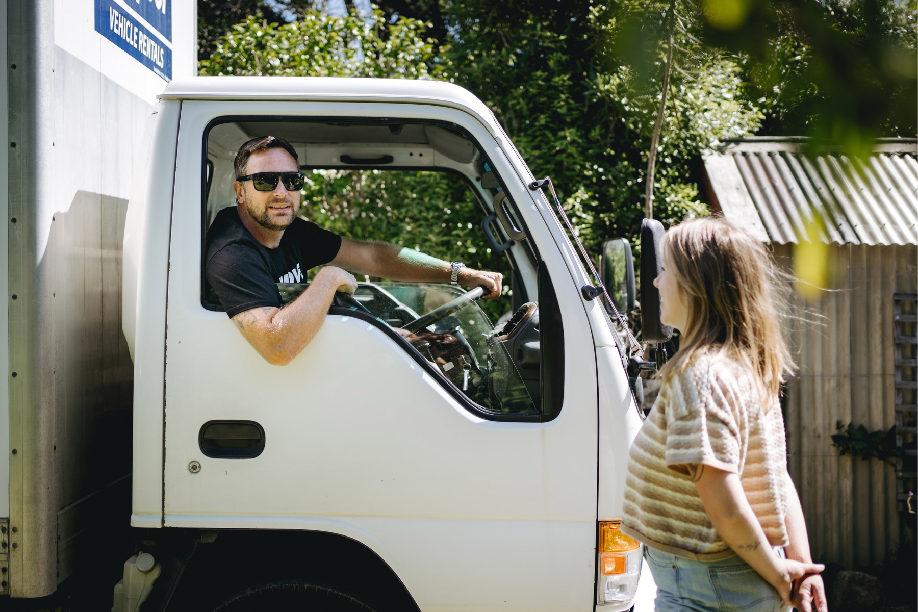 Student talking to student moving team in a moving truck