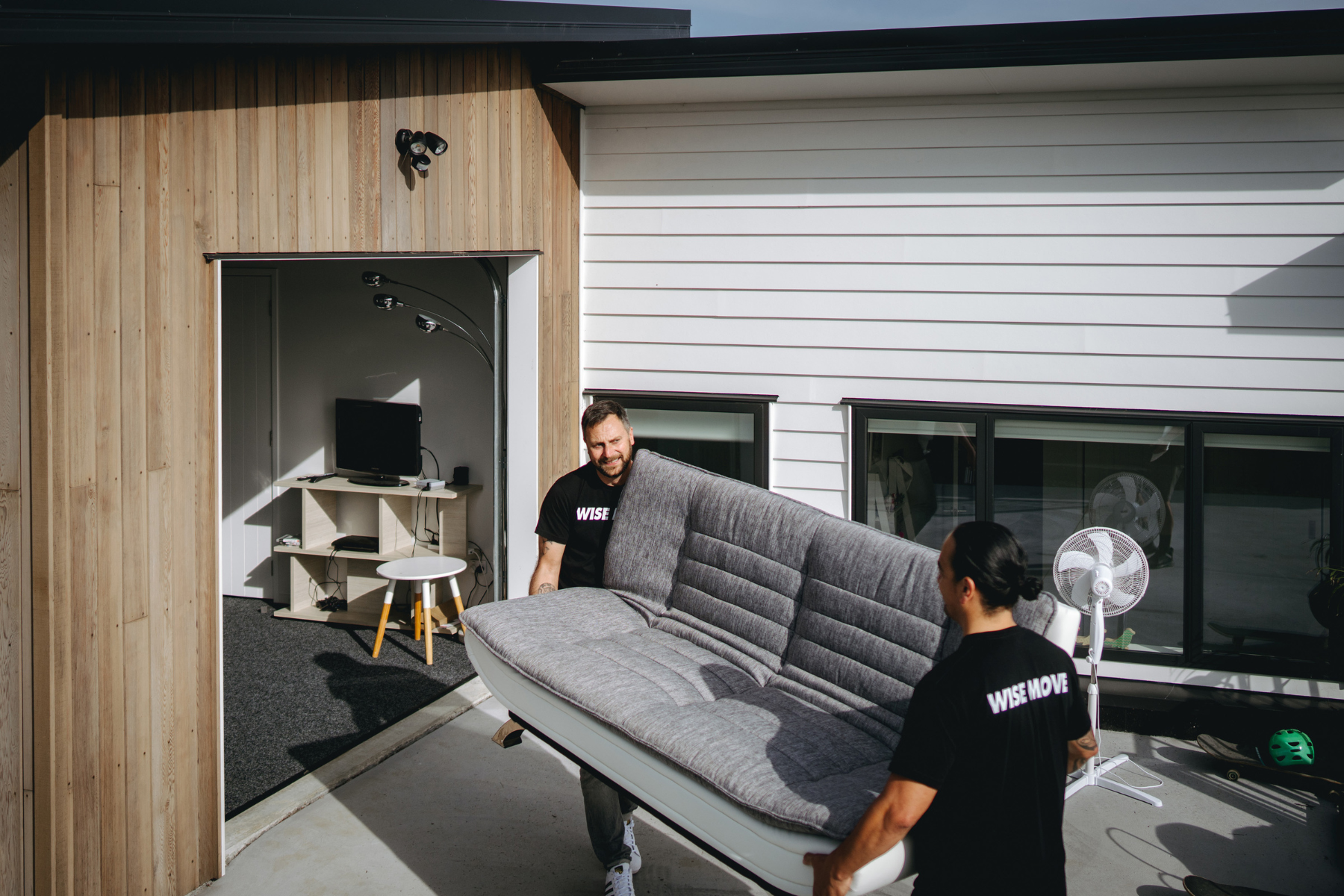 student-friendly movers moving a sleeper couch into student accommodation