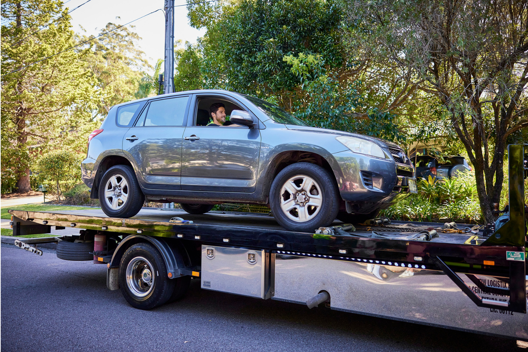 New car being transported on a transport truck