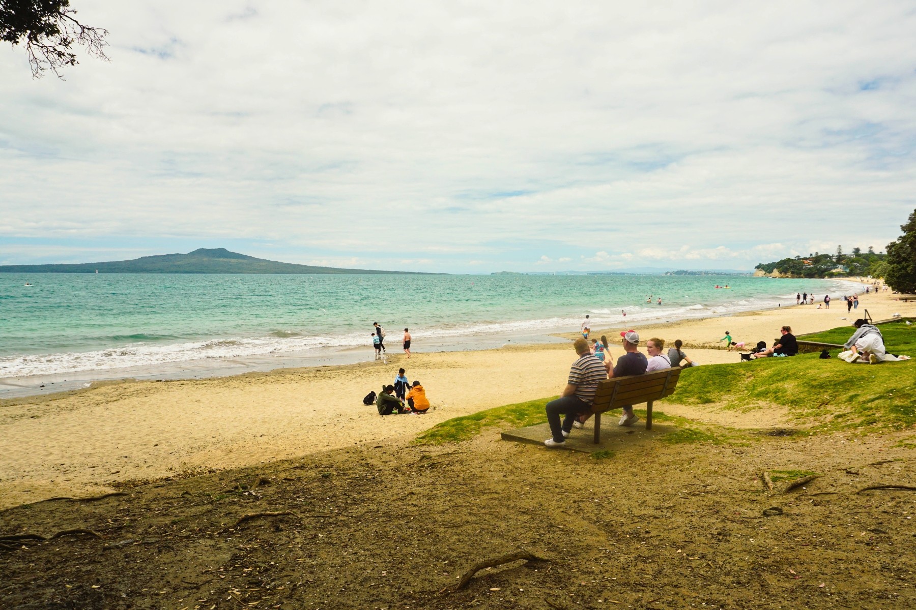 Families dressed for early summer at the beach, New Zealand
