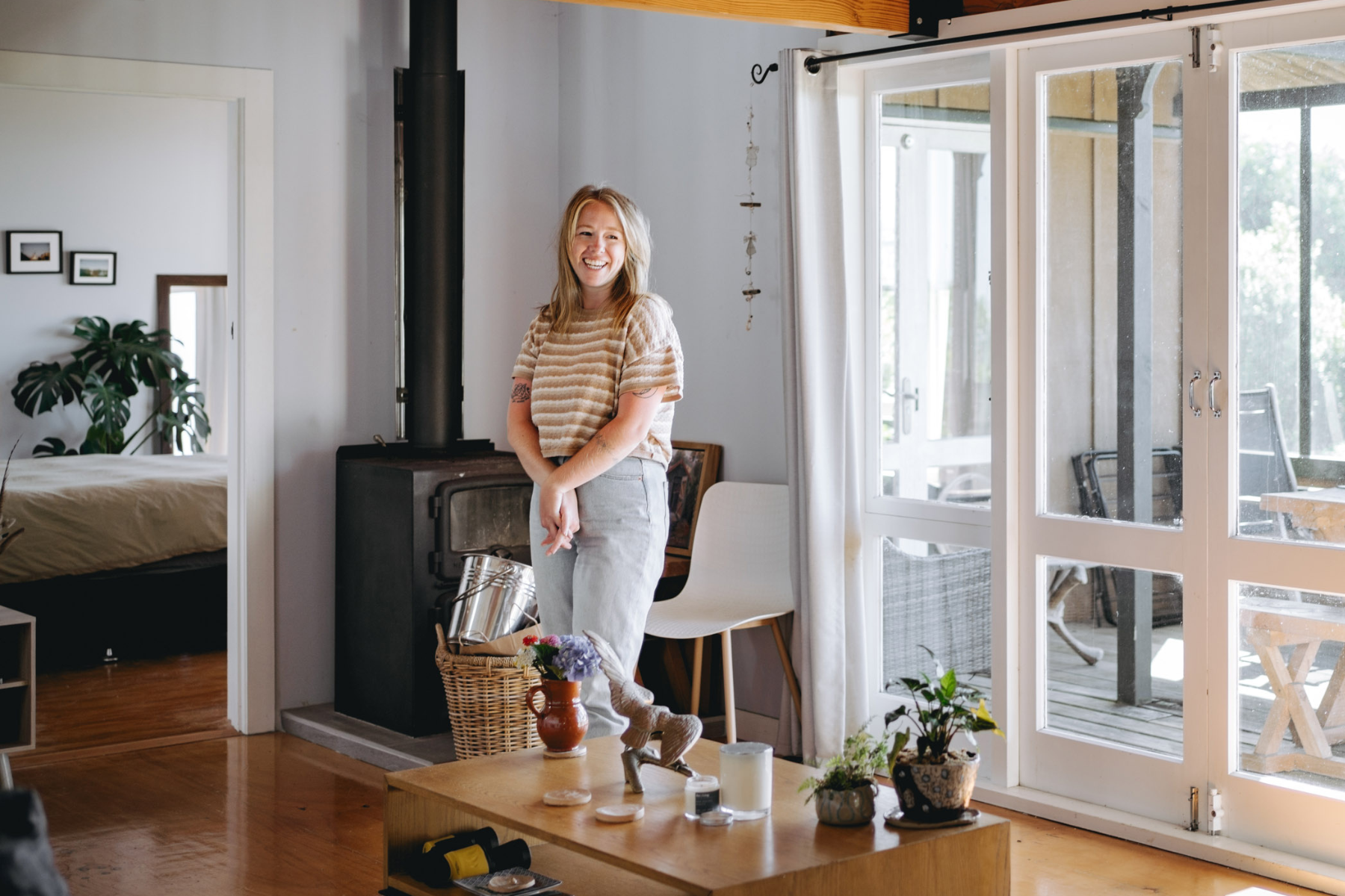 female student standing smiling in her student accommodation