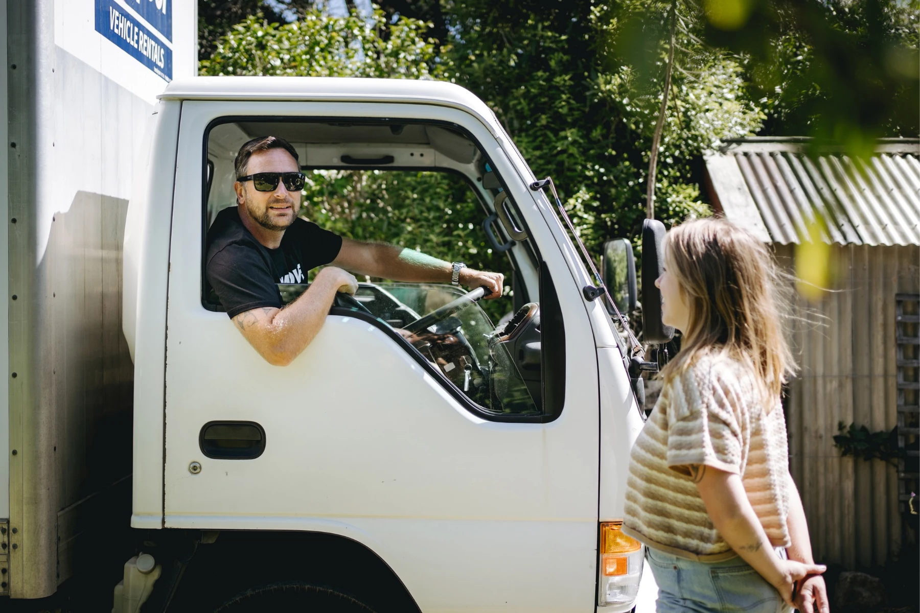 Student talking to student moving team in a moving truck