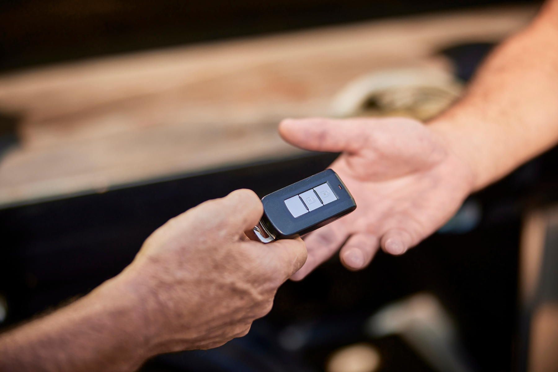 man handing over car keys to for personal driveaway car transportation