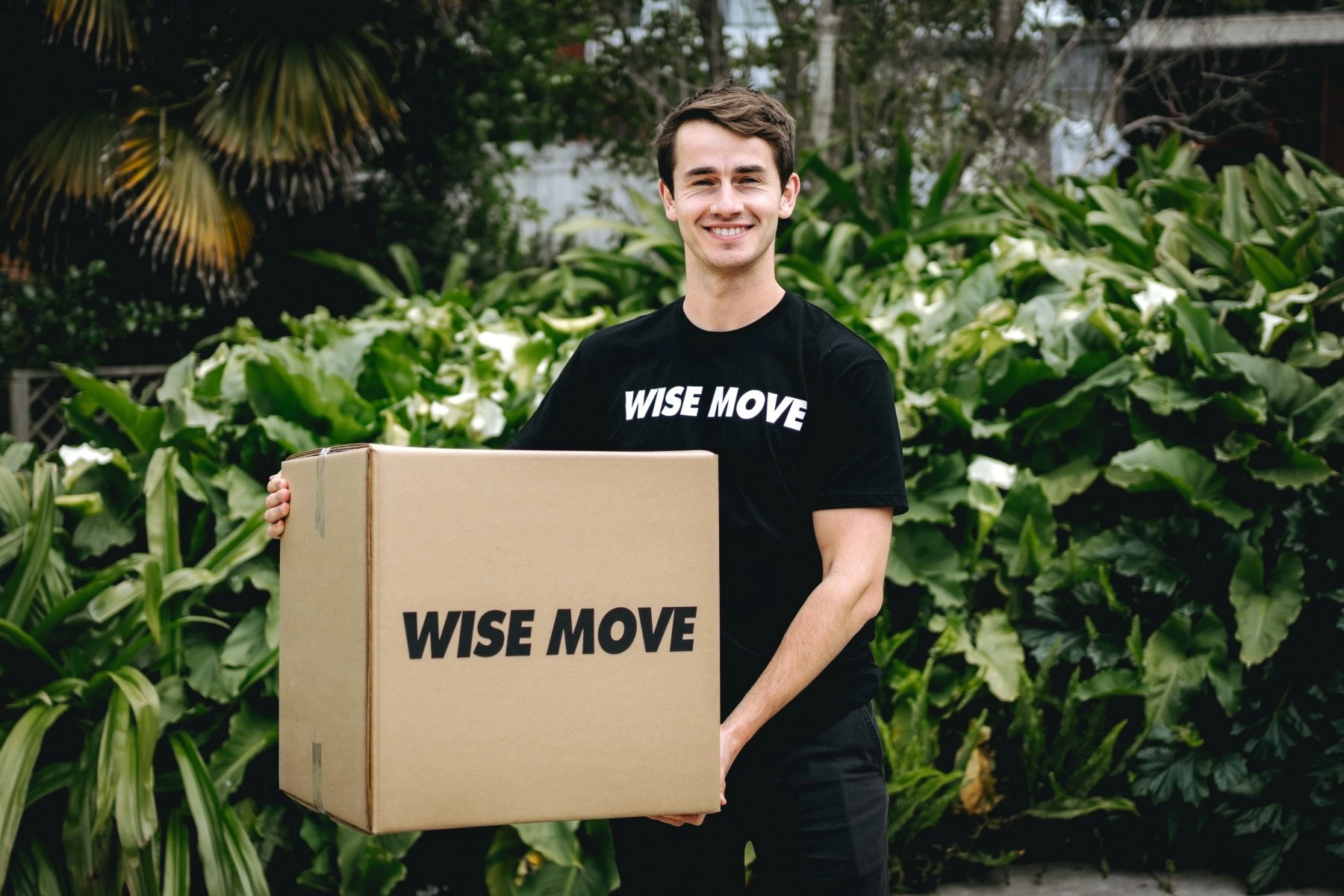 A mover carrying a customer's boxed item during a home move