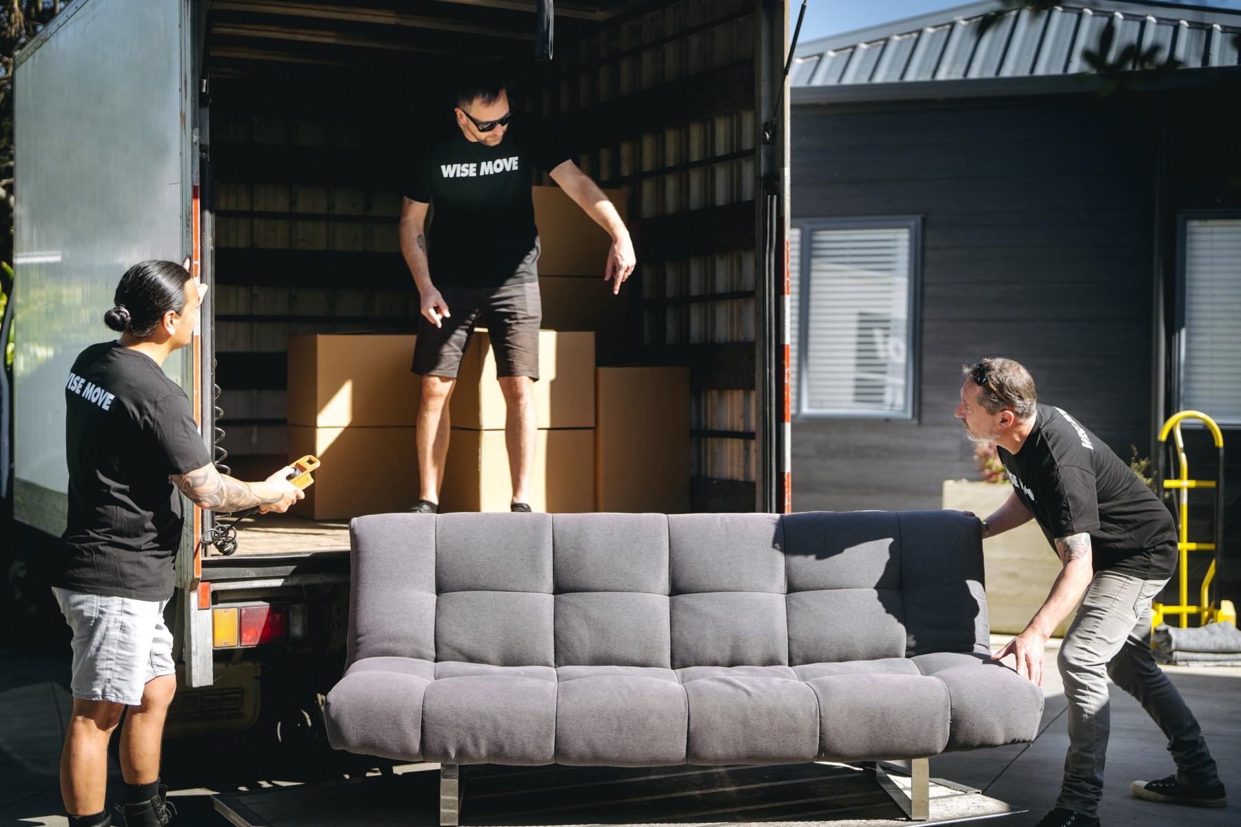Couch being loaded on truck for furniture pickup for the Salvation Army