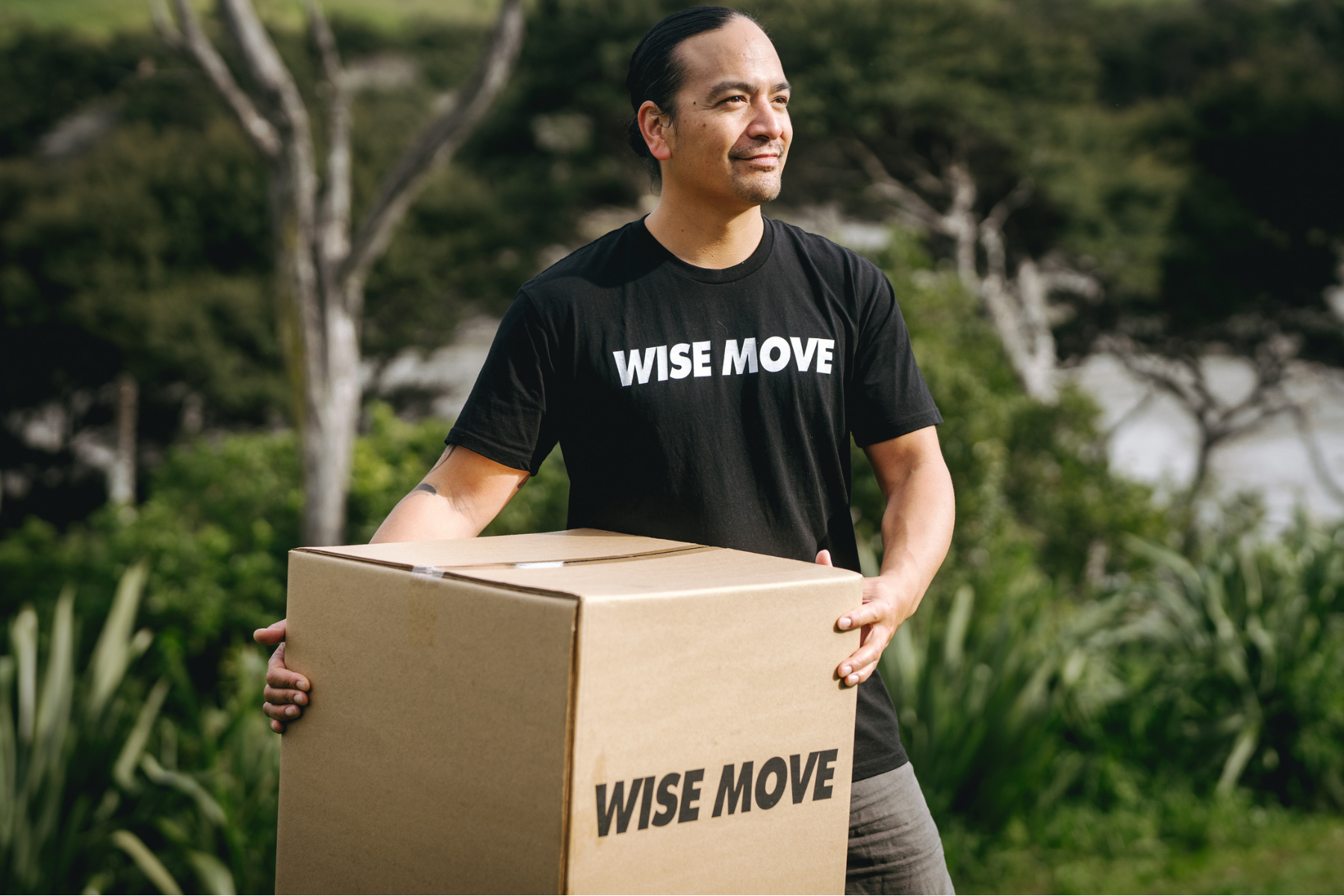 Mover holding a moving box in New Zealand