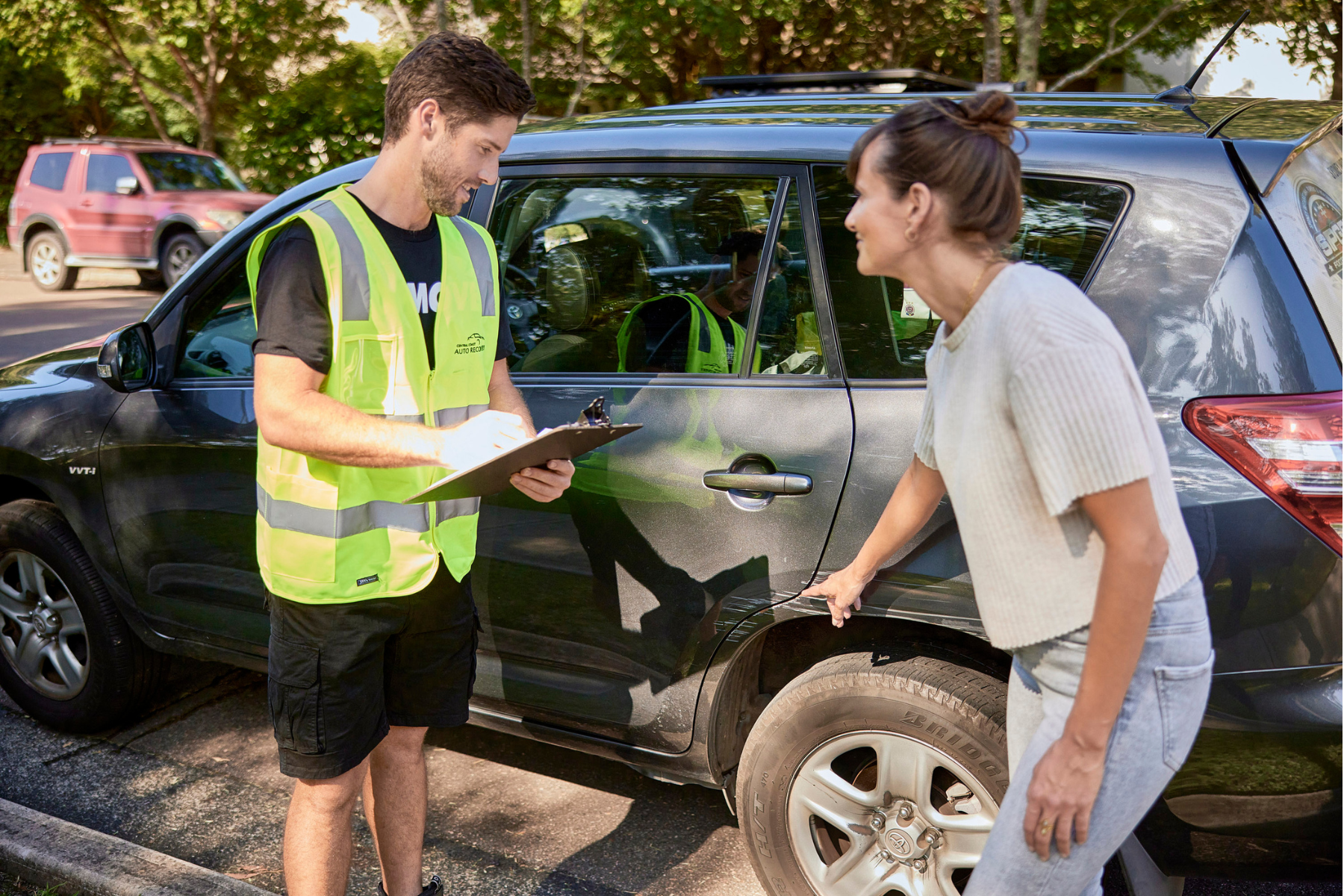 car transporter and car owner going through pre-existing damages on car before transportation