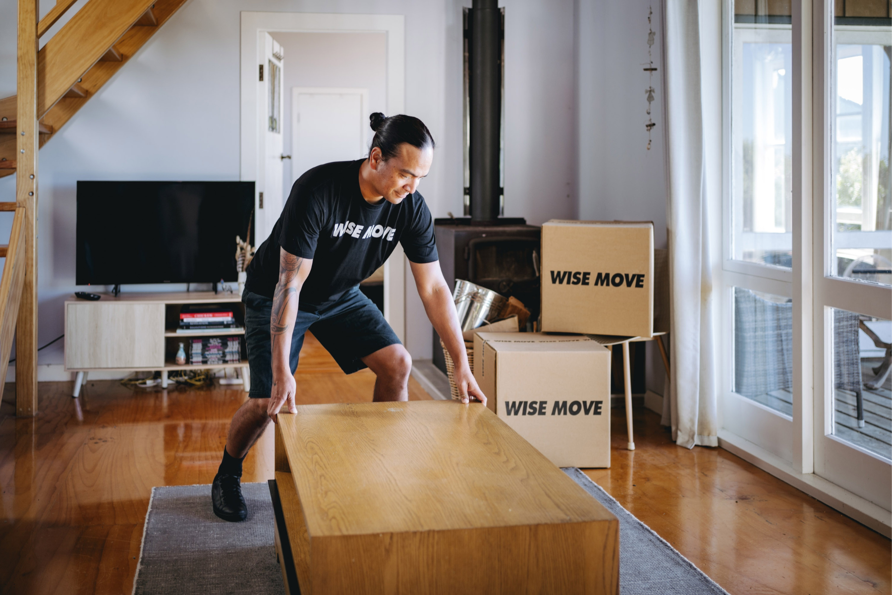 student moving team helping to set up coffee table in student accommodation