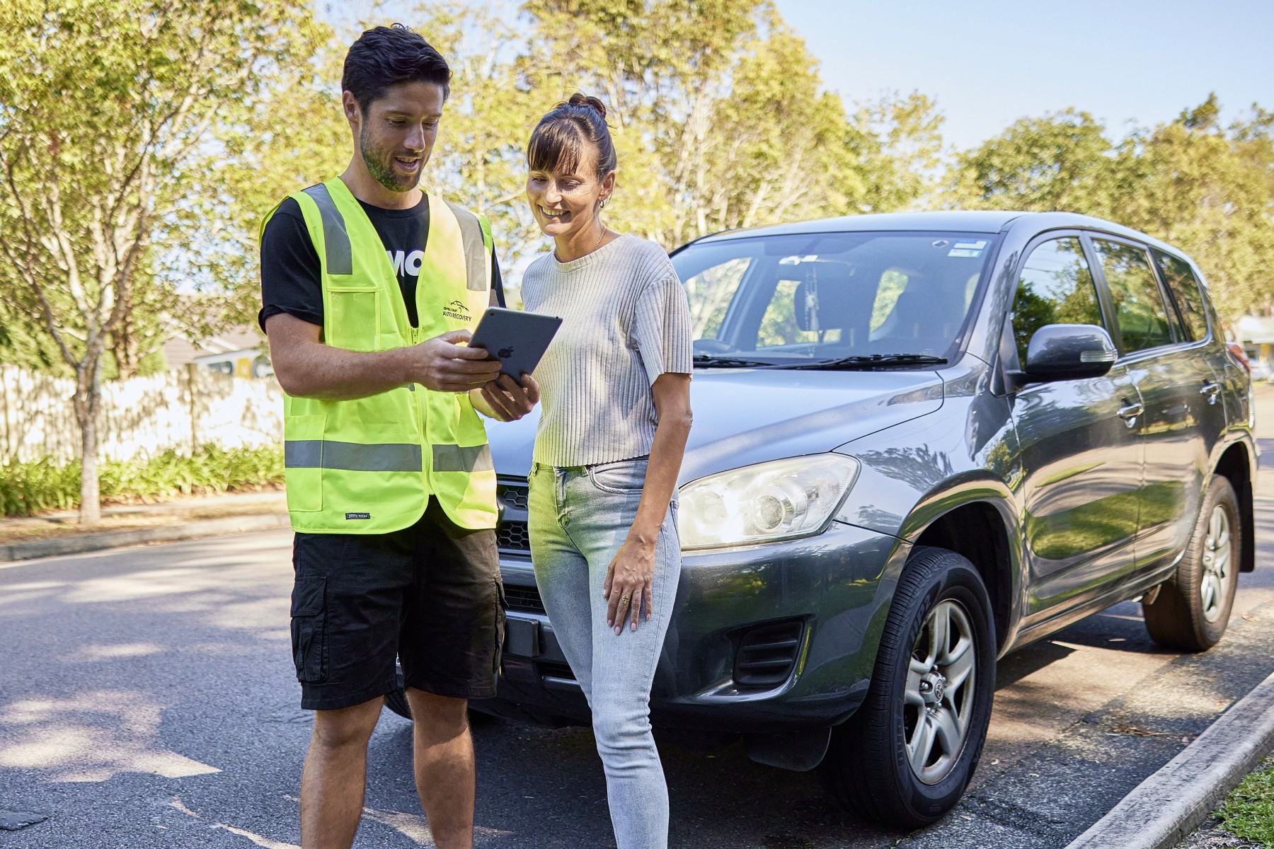 Woman speaking to car transport team member